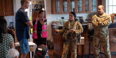 U.S. Army Sgt. Durana Amoncia, center, assigned to Bravo Company, 2nd Battalion, 211th Aviation Regiment, Hawaii Army National Guard, provides a pre-flight safety briefing to civilian passengers, Lihue, Hawaii, Sept 10, 2026.
