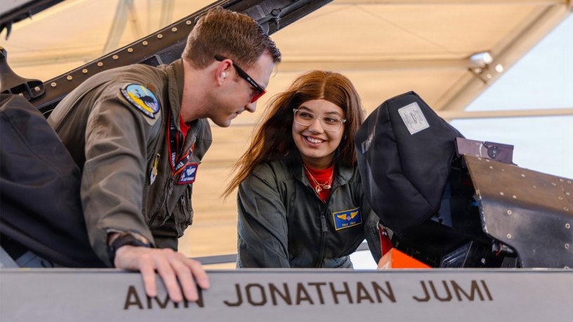 Air Force Maj. Michael Grimmer, a pilot assigned to the 416th Flight Test Squadron, shows an F-16 Fighting Falcon to Hailey Macleod, an honorary pilot, at Edwards Air Force Base, Calif., Sept. 11, 2026.