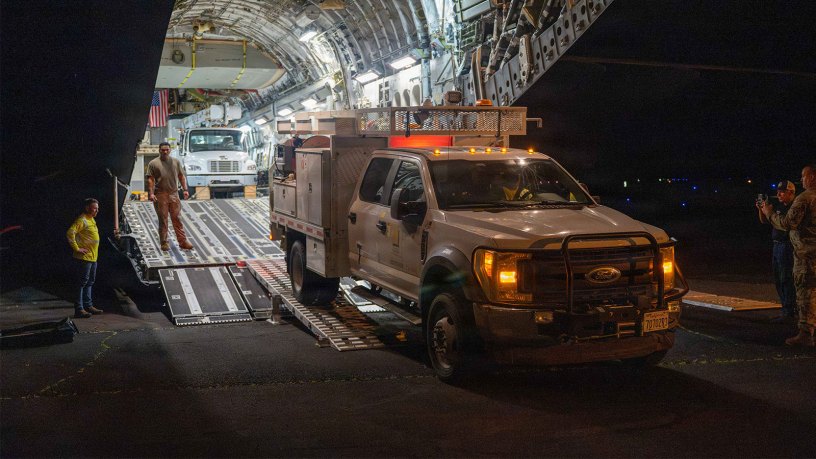 An electrical infrastructure vehicle exits the back of a C-17 Globemaster III, assigned to the 535th Airlift Squadron, at Lihue Airport, Sept. 12, 2026. Transporting the vehicles by C-17 helped position essential equipment on Kauai for ongoing hurricane response and recovery efforts. (U.S. Air Force photo by Senior Airman Aden Brown)