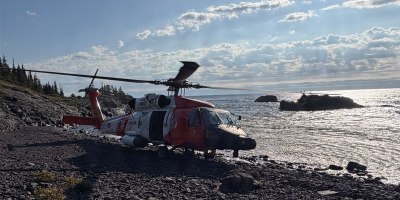 A U.S. Coast Guard Air Station Traverse City MH-60 Jayhawk helicopter sits on the shore of Isle Royale, Michigan, Sept. 11, 2026. The helicopter crew transported Michigan State Police troopers and K-9 units to the island to search for a missing hiker. (U.S. Coast Guard photo, courtesy Air Station Traverse City)