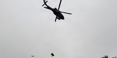 Alaska Army National Guard Staff Sgt. Steven Gildersleeve, critical care flight medic assigned to G Company, 2nd Battalion, 211th General Support Aviation Battalion, rides the hoist with an injured mountain biker in a litter during a rescue along the Winner Creek Trail near Girdwood, Alaska, Sept. 13, 2026.