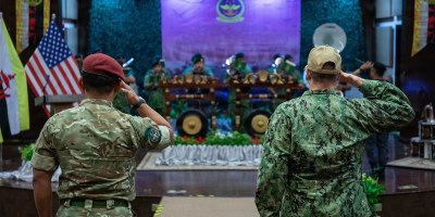 Col. Muhammad Suwardi Ariffin, left, chief of staff of Joint Force Headquarters, Royal Brunei Armed Forces, and U.S. Coast Guard Capt. Michael Ross, right, commodore of Expeditionary Cutter Squadron, render salutes during the playing of the national anthems of Brunei and the United States during the opening ceremony for exercise Cooperation Afloat Readiness and Training (CARAT) Brunei 2026, Sept. 14, 2026.