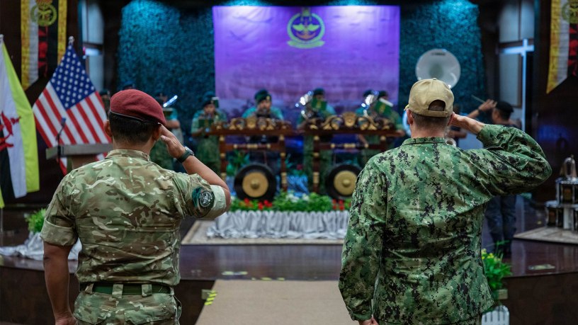 Col. Muhammad Suwardi Ariffin, left, chief of staff of Joint Force Headquarters, Royal Brunei Armed Forces, and U.S. Coast Guard Capt. Michael Ross, right, commodore of Expeditionary Cutter Squadron, render salutes during the playing of the national anthems of Brunei and the United States during the opening ceremony for exercise Cooperation Afloat Readiness and Training (CARAT) Brunei 2026, Sept. 14, 2026.