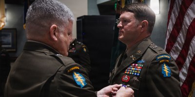 U.S. Army Brig. Gen. John W. Sannes, Deputy Commanding General-Operations, 1st Special Forces Command (Airborne), pins the Purple Heart on Chief Warrant Officer 2 Corey L. Cook during an award ceremony at Fort Carson, Colo., Sept. 15, 2026.