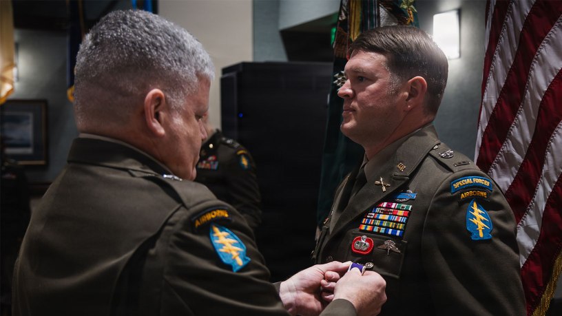 U.S. Army Brig. Gen. John W. Sannes, Deputy Commanding General-Operations, 1st Special Forces Command (Airborne), pins the Purple Heart on Chief Warrant Officer 2 Corey L. Cook during an award ceremony at Fort Carson, Colo., Sept. 15, 2026.