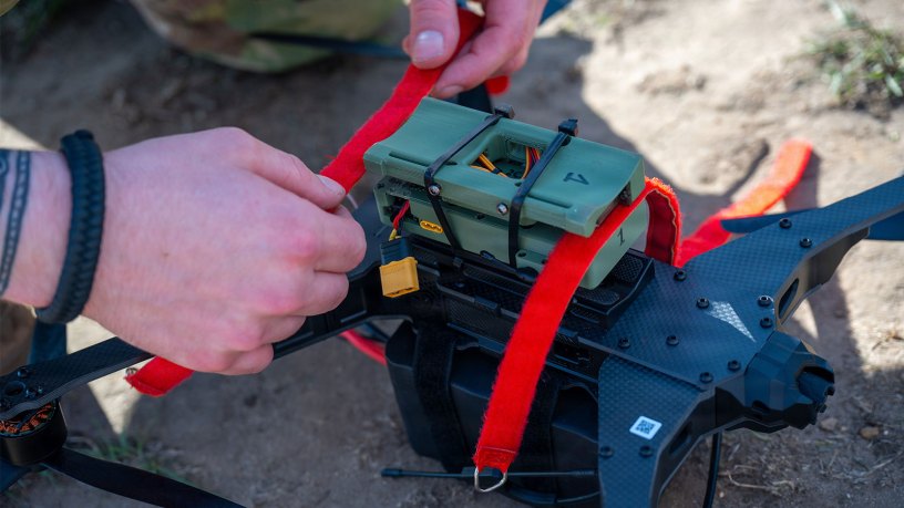 A team USA member secures equipment to a drone during the Military International Drone Racing Tournament and British Army Tactical Drone Competition at the Royal Military Academy Sandhurst, England, Sept. 15, 2026.