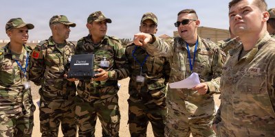 Utah Air National Guard Staff Sgt. Ryan Bigham, 151st Civil Engineer Squadron (right) and Utah Air National Guard Technical Sgt. Michael Bennion, 151st Security Forces Squadron, review instructions as counterparts from the Royal Moroccan Armed Forces pilot a small unmanned aerial system during a drone training course in Agadir, Morocco, September 16, 2026.
