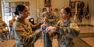 Illinois Army National Guard Capt. Marketa Jimenez, left, Spc. Izaiah Moreno, middle, and 1st Sgt. Dolores Lechner cases the colors during Casing Ceremony for C. Co., 341st Military Intelligence Battalion, September 19, 2026, at General Jones Armory.