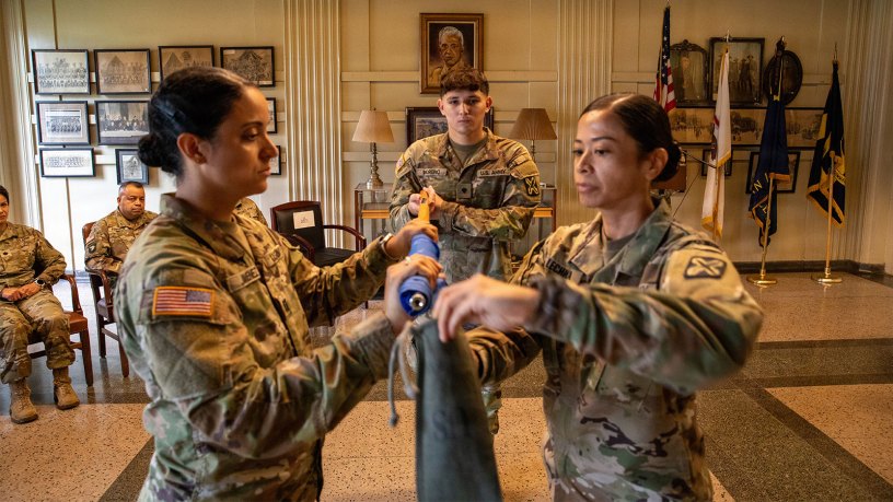 Illinois Army National Guard Capt. Marketa Jimenez, left, Spc. Izaiah Moreno, middle, and 1st Sgt. Dolores Lechner cases the colors during Casing Ceremony for C. Co., 341st Military Intelligence Battalion, September 19, 2026, at General Jones Armory.