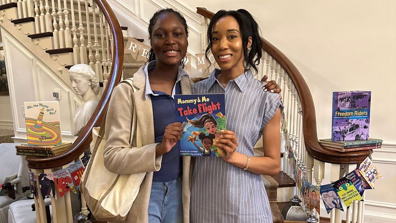 U.S. Air Force Staff Sgt. Trina Quirindongo, a member of the 113th Wing, District of Columbia Air National Guard, and her daughter, Jade, pose with their children’s book, “Mommy and Me Take Flight,” during the #ReadMoreMaryland Campaign Summer Reading Celebration at Government House in Annapolis, Maryland, June 27, 2026.