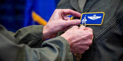 U.S. Air Force Lt. Gen. Jason T. Hinds, U.S. Air Forces in Europe – U.S. Air Forces Africa commander, pins a Distinguished Flying Cross medal onto a U.S. Air Force pilot during a ceremony in Essen, Germany, Sept. 22, 2026.