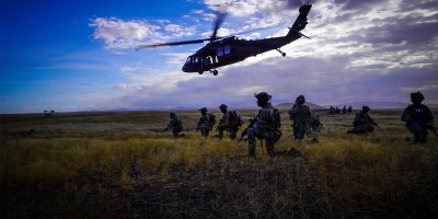 FBI agents take a knee as an Idaho Army National Guard UH-60 Black Hawk helicopter departs a landing zone during Exercise Hellgate at Camp Orchard near Boise, Idaho, Sept. 22, 2026.