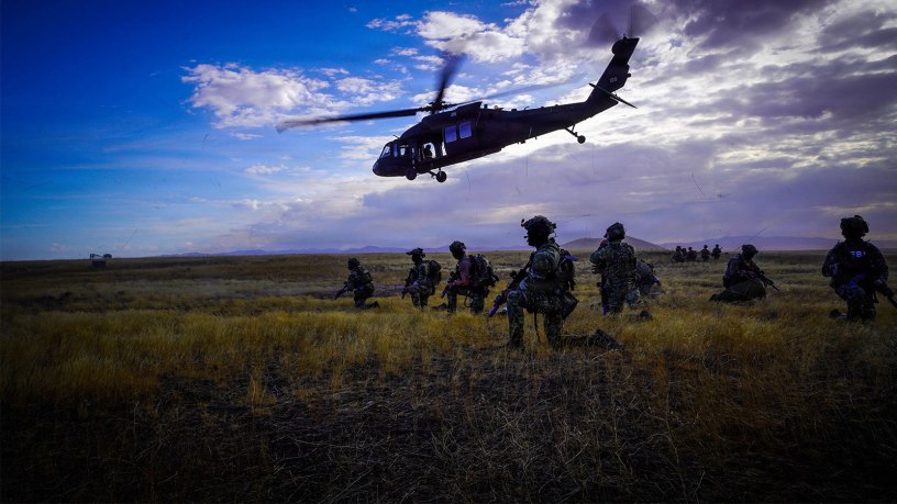 FBI agents take a knee as an Idaho Army National Guard UH-60 Black Hawk helicopter departs a landing zone during Exercise Hellgate at Camp Orchard near Boise, Idaho, Sept. 22, 2026.