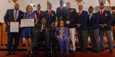U.S. Marine Corps Maj. Gen. Douglas K. Clark, deputy commander, Marine Forces Reserve and Marine Forces South, center, and the New Orleans Montford Point Marine Association poses for a photo with retired Pfc. Henry Edwards, a Montford Point Marine, during a reception in honor of Montford Point Marines at the Bethel Ame Church in New Orleans, Sept. 27, 2026.