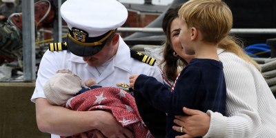 Lt. Cmdr. Charles Linder meets his new daughter, Charlotte, for the first time as the nuclear-powered fast-attack submarine USS Idaho (SSN 799) returns to Naval Submarine Base New London in Groton, Conn., Sept. 28, 2026, following a four-month deployment to the U.S. European Command area of responsibility.