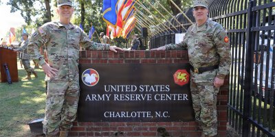 Maj. Gen. Michael Dougherty, commanding general of the 80th Training Command, left, and Maj. Gen. David M. Samuelsen, commanding general of the 108th Training Command (Initial Entry Training), stand beside the Charlotte Army Reserve Center sign following the 108th Training Command’s deactivation and casing of the colors ceremony in Charlotte, N.C., Sept. 27, 2026.
