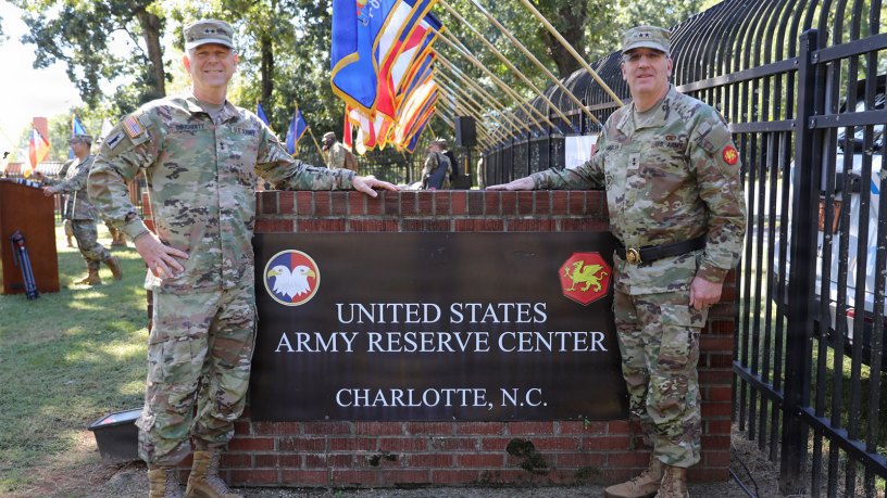 Maj. Gen. Michael Dougherty, commanding general of the 80th Training Command, left, and Maj. Gen. David M. Samuelsen, commanding general of the 108th Training Command (Initial Entry Training), stand beside the Charlotte Army Reserve Center sign following the 108th Training Command’s deactivation and casing of the colors ceremony in Charlotte, N.C., Sept. 27, 2026.