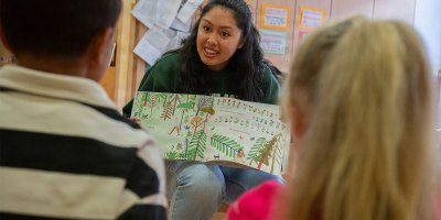 U.S. Air Force Airman 1st Class Michelle Sies, 86th Airlift Wing Public Affairs specialist and volunteer, reads a children's book to students at Kita Villa Winzig, Kaiserslautern, Germany, June 11, 2026. The German-American Reading Program is an 86th AW Host Nation Office and Kita Villa Winzig community outreach effort that introduces German children to the English language at an early age. (U.S. Air Force photo by Senior Airman Trevor Calvert)