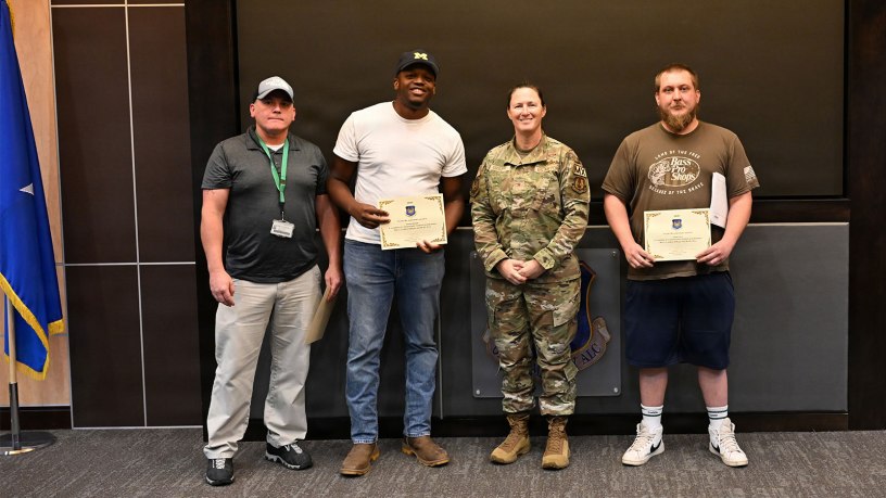 A team from the 547th Propulsion Maintenance Squadron pose with Brig. Gen. Lindsay Droz, commander, Oklahoma City Logistics Complex after being recognized for their cost savings initiative. (U.S. Air Force photo by Corey Robertson)