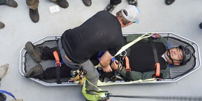 A U.S. Air Force Special Operations Command Airman demonstrates securing a patient to a litter to members of the Thai Border Patrol Police (BPP) during Tactical Emergency Casualty Care (TECC) week at Chiang Mai, Thailand, Aug. 26, 2026.