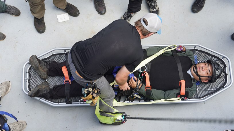 A U.S. Air Force Special Operations Command Airman demonstrates securing a patient to a litter to members of the Thai Border Patrol Police (BPP) during Tactical Emergency Casualty Care (TECC) week at Chiang Mai, Thailand, Aug. 26, 2026.
