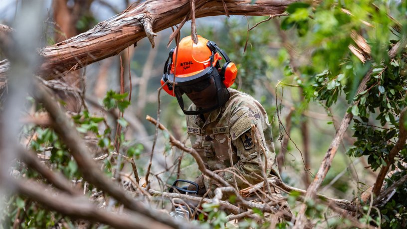 U.S. Army Sgt. Jacob Delos Reyes, support personnel assigned to Task Force Kauai, Hawaii National Guard, uses a chainsaw to cut fallen trees in Kokee State Park, Sept. 10, 2026.