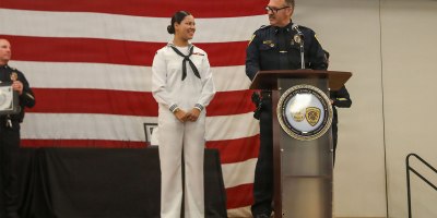 National City Police Department Lt. Kenneth Springer awards the Citizens Meritorious Service Medal to U.S. Hospital Corpsman 3rd Class Nevaeh Funderburk, assigned to Wasp-class amphibious assault ship USS Essex (LHD 2), at the Martin Luther King Jr. Community Center in San Diego, Sep. 29, 2026.