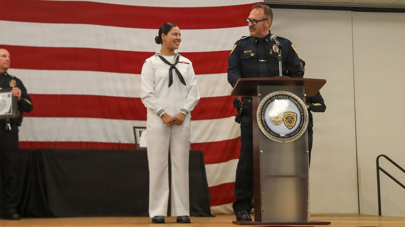 National City Police Department Lt. Kenneth Springer awards the Citizens Meritorious Service Medal to U.S. Hospital Corpsman 3rd Class Nevaeh Funderburk, assigned to Wasp-class amphibious assault ship USS Essex (LHD 2), at the Martin Luther King Jr. Community Center in San Diego, Sep. 29, 2026.