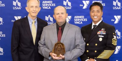 Dr. David Smith, Defense Health Agency deputy director, Bradley Reddall, and Force Master Chief PatrickPaul C. Mangaran, DHA command senior enlisted leader, pose for a photo at the Armed Services YMCA 2026 Angels of the Battlefield Gala in Arlington, Virginia, Sept. 23.