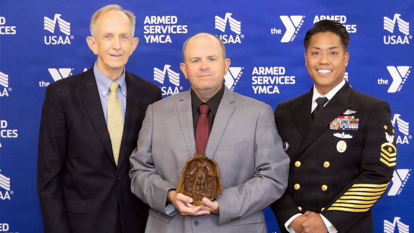 Dr. David Smith, Defense Health Agency deputy director, Bradley Reddall, and Force Master Chief PatrickPaul C. Mangaran, DHA command senior enlisted leader, pose for a photo at the Armed Services YMCA 2026 Angels of the Battlefield Gala in Arlington, Virginia, Sept. 23.