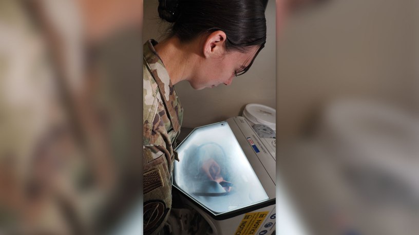 Air Force Capt. Kellie Jones, from the 10th Dental Squadron at the U.S. Air Force Academy, uses an air abrasion tool to clean a new crown she created using a 3d digital model, during a joint Digital Dentistry Course at Fort Carson's Smith Dental Clinic on 29 Sep 26.