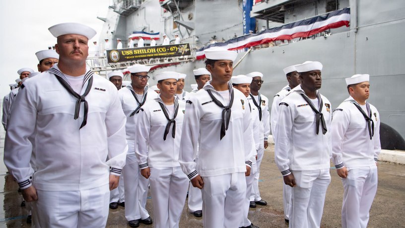 The crew of the Ticonderoga-class guided-missile cruiser USS Shiloh (CG 67) disembarks the ship for the final time upon its decommissioning during a ceremony onboard Joint Base Pearl Harbor-Hickam, Hawaii, Sept. 30, 2026.