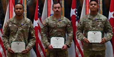 Staff Sgt. Kalob Mitchell, Spc. Nicholas Cabo, and Sgt. Xavier Jones, 6th Battalion, 56th Air Defense Artillery Regiment, 1st Cavalry Division Artillery, poses for a picture after the Purple Heart ceremony on Oct. 1 at the III Armored Corps headquarters building at Fort Hood, Texas.