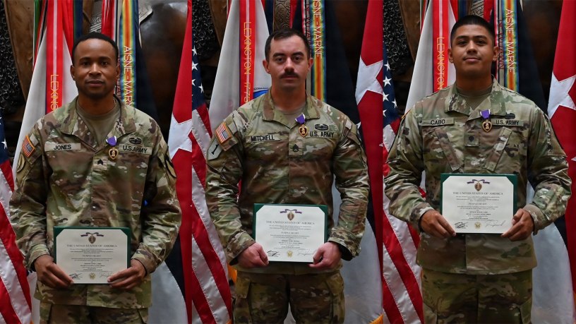 Staff Sgt. Kalob Mitchell, Spc. Nicholas Cabo, and Sgt. Xavier Jones, 6th Battalion, 56th Air Defense Artillery Regiment, 1st Cavalry Division Artillery, poses for a picture after the Purple Heart ceremony on Oct. 1 at the III Armored Corps headquarters building at Fort Hood, Texas.