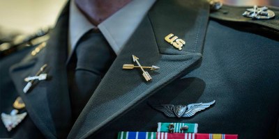 A 390A graduate dons their new Special Forces regimental distinctive insignia following the Activation and Induction ceremony at the U.S. Army John F. Kennedy Special Warfare Center and School, the Special Operations Center of Excellence, at the JFK Auditorium on Fort Bragg, N.C., Oct. 2, 2026.