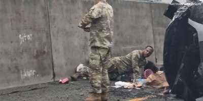 U.S. Army Soldiers and civilian bystanders assist two children following a vehicle crash on Interstate 5 near DuPont, Washington,Oct. 5, 2026. Sgt. 1st Class Jeff Hytower, Sgt. Ricardo A. Nunez and Sgt. Alexis McKay were among those who intervened to protect the children during the incident. (Courtesy photo by Nathan Wilkinson)