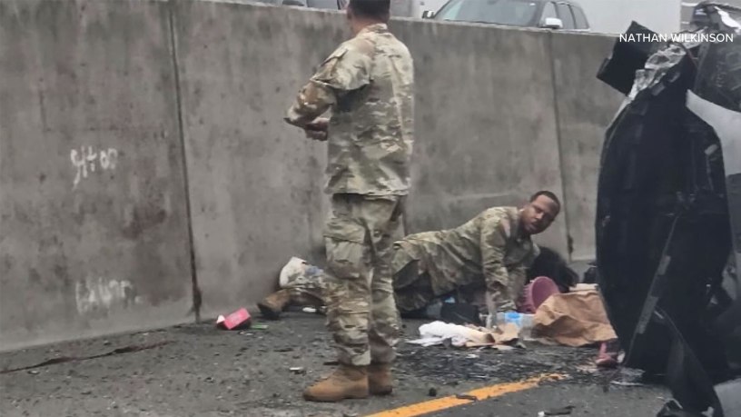 U.S. Army Soldiers and civilian bystanders assist two children following a vehicle crash on Interstate 5 near DuPont, Washington,Oct. 5, 2026. Sgt. 1st Class Jeff Hytower, Sgt. Ricardo A. Nunez and Sgt. Alexis McKay were among those who intervened to protect the children during the incident. (Courtesy photo by Nathan Wilkinson)