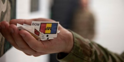 A planning officer assigned to the 2nd Battalion 37th Armored Regiment, NATO Forward Land Forces (FLF) Battle Group-Poland, holds markers at the end of the table top Alert Exercise at Bemowo Piskie Training Area, Poland on Oct. 5, 2026.