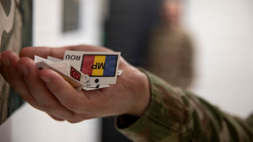 A planning officer assigned to the 2nd Battalion 37th Armored Regiment, NATO Forward Land Forces (FLF) Battle Group-Poland, holds markers at the end of the table top Alert Exercise at Bemowo Piskie Training Area, Poland on Oct. 5, 2026.