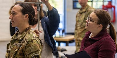 Elizabeth Rhonenus, a human factors engineer with the Aviation Flight Test Directorate, measures a Soldier from the 101st Combat Aviation Brigade before the first helicopter test of the Advanced Inflight Relief Universal System (AIRUS) at Fort Campbell, Kentucky, Oct. 5, 2026.