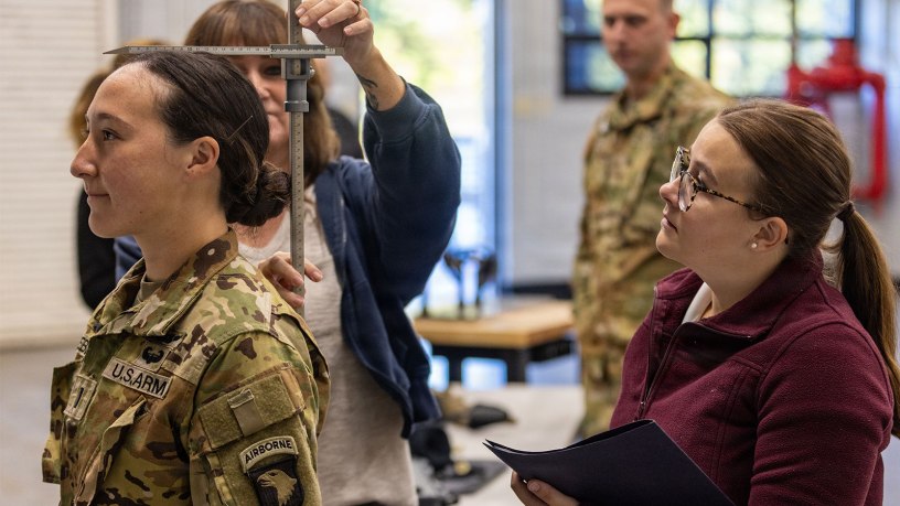 Elizabeth Rhonenus, a human factors engineer with the Aviation Flight Test Directorate, measures a Soldier from the 101st Combat Aviation Brigade before the first helicopter test of the Advanced Inflight Relief Universal System (AIRUS) at Fort Campbell, Kentucky, Oct. 5, 2026.
