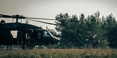 A U.S. Army UH-60 Black Hawk helicopter assigned to the 12th Combat Aviation Brigade prepares to take off while air defenders from the 52nd Air Defense Artillery Brigade stand near a U.S. Army SGT STOUT vehicle during Operation Skyfall II, Oct. 6, 2026, at the Grafenwoehr Training Area, Germany.