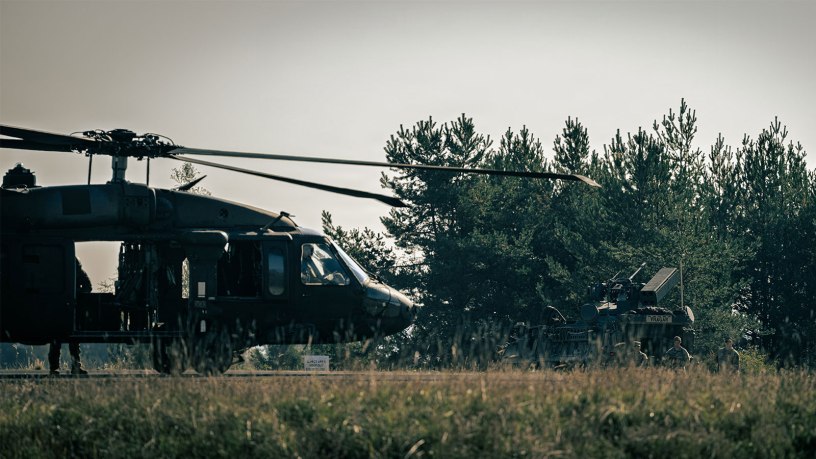 A U.S. Army UH-60 Black Hawk helicopter assigned to the 12th Combat Aviation Brigade prepares to take off while air defenders from the 52nd Air Defense Artillery Brigade stand near a U.S. Army SGT STOUT vehicle during Operation Skyfall II, Oct. 6, 2026, at the Grafenwoehr Training Area, Germany.