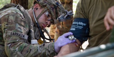 Army Reserve Sgt. Michael Larraza, a practical nursing specialist assigned to the 628th Forward Resuscitative Surgical Detachment, 228th Field Hospital, measures a patient's blood pressure at Fort Polk, Louisiana.