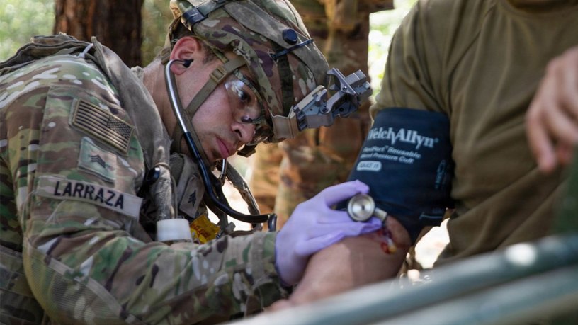 Army Reserve Sgt. Michael Larraza, a practical nursing specialist assigned to the 628th Forward Resuscitative Surgical Detachment, 228th Field Hospital, measures a patient's blood pressure at Fort Polk, Louisiana.