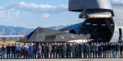 Airmen assigned to the Air Force Reserve’s 512th Airlift Wing pose with personnel from Lockheed Martin, Air & Space Forces Magazine and the Smithsonian Institution for a photo in front of a wingless F117A Nighthawk before it is uploaded to a C-5M Super Galaxy in Palmdale, Calif., Oct. 5, 2026.