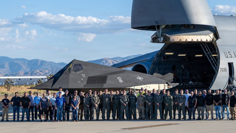 Airmen assigned to the Air Force Reserve’s 512th Airlift Wing pose with personnel from Lockheed Martin, Air & Space Forces Magazine and the Smithsonian Institution for a photo in front of a wingless F117A Nighthawk before it is uploaded to a C-5M Super Galaxy in Palmdale, Calif., Oct. 5, 2026.