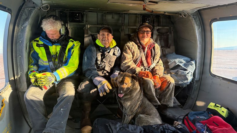 A Nome Volunteer Fire Department emergency medical technician and two rescued boaters ride in a Nome based Alaska Army National Guard UH-60L Black Hawk, assigned to the 1-168th General Support Aviation Battalion, during a rescue mission over Northwest Alaska Oct. 6, 2026.