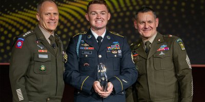 U.S. Army Staff Sgt. Colin Doyle, assigned to the 75th Ranger Regiment, is announced as the 2026 NCO of the Year by U.S. Army Vice Chief of Staff, Gen. Christopher LaNeve, and Sgt. Maj. of the Army Michael Weimer at the 2026 AUSA Annual Meeting and Exposition in Washington, D.C., Oct. 12, 2026. (U.S. Army photo by Staff Sgt. Alexander Nieves)